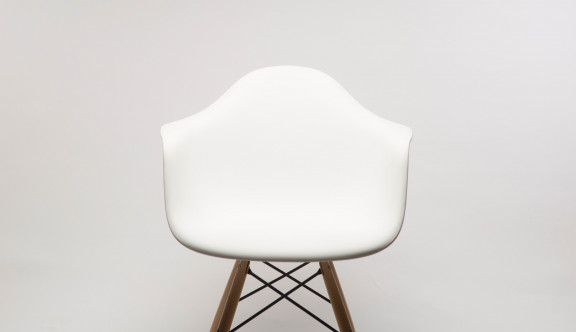 A white chair against a wall