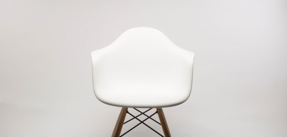 A white chair against a wall