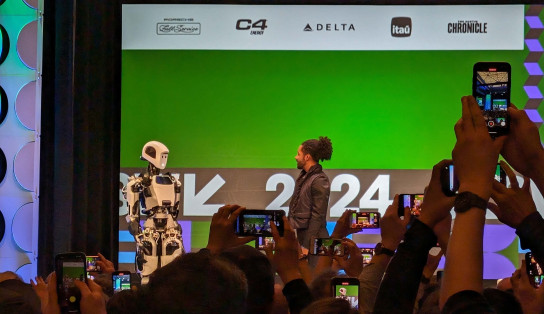 Speaker chatting to a robot at SXSW 2024