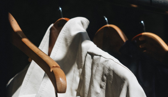 A white jacket hanging on a rack